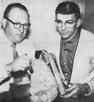 PHOTO: Andrew Genzoli discusses track imprint with Jerry Crew October 5, 1958. Track was found along side Crew's Caterpiller tractor when he arrived for work on the road construction near Bluff Creek, California. Crew also maintained a equipment storage area near the Louse Camp bridge...